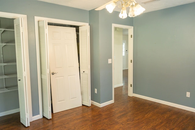 unfurnished bedroom featuring dark hardwood / wood-style floors and multiple closets