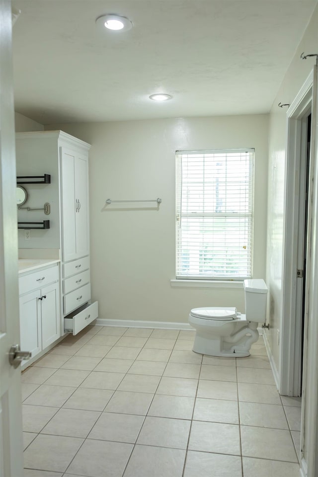 bathroom with vanity, tile patterned floors, and toilet