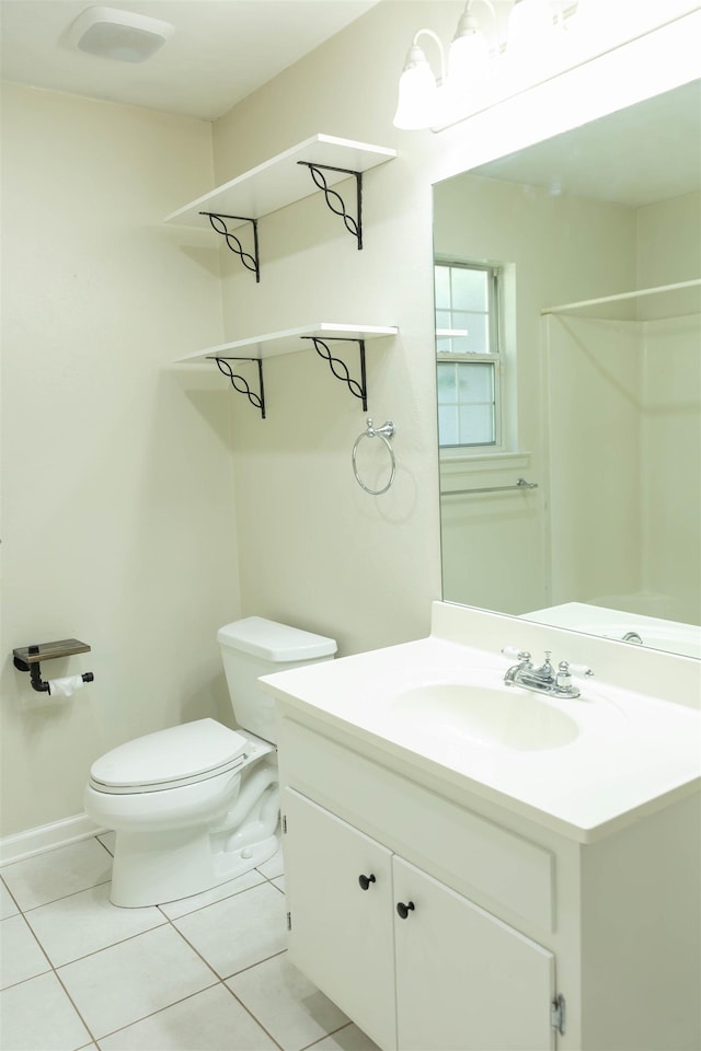 bathroom featuring vanity, walk in shower, tile patterned floors, and toilet