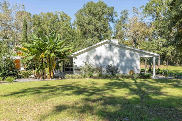 view of side of home with a lawn