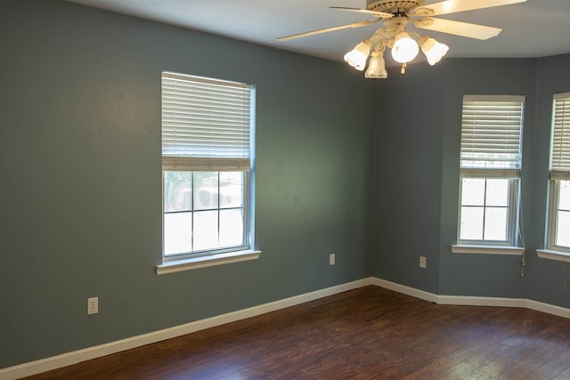 unfurnished room with ceiling fan and dark hardwood / wood-style flooring