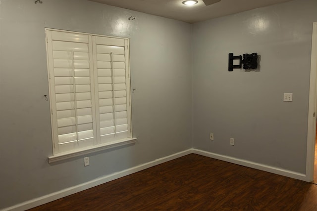 unfurnished room with dark hardwood / wood-style floors