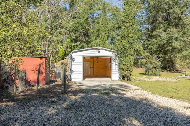 view of outdoor structure featuring a garage and a lawn