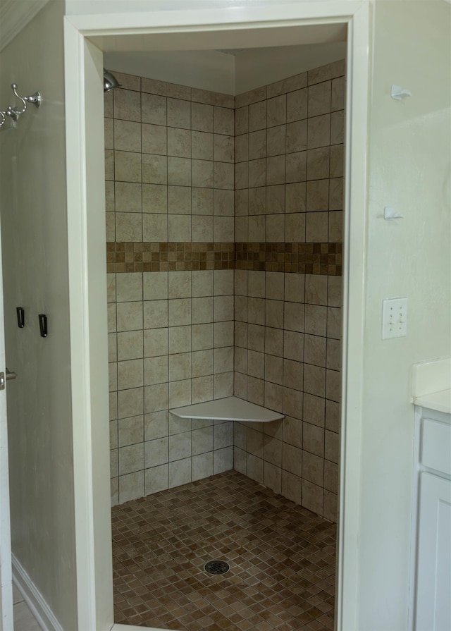 bathroom with vanity and tiled shower