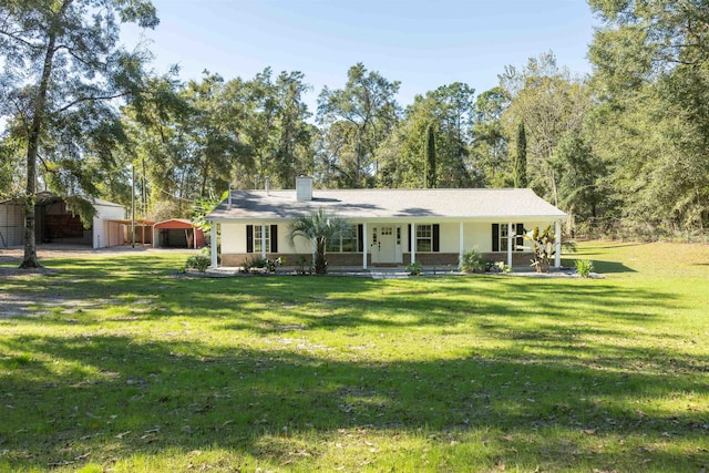 ranch-style house featuring a porch, an outbuilding, a garage, a carport, and a front yard