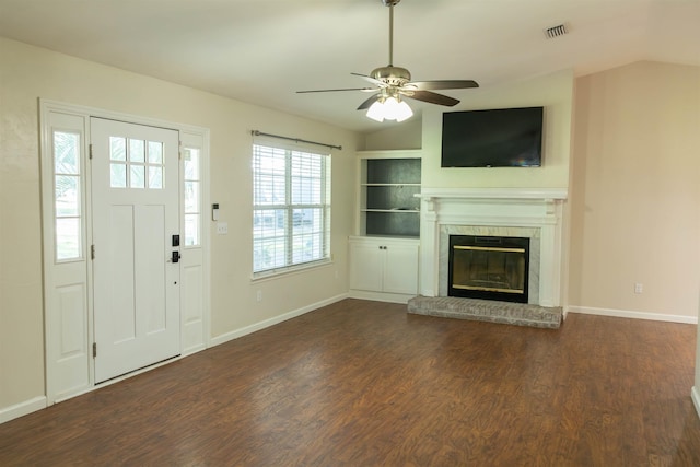 unfurnished living room with vaulted ceiling, a brick fireplace, ceiling fan, and dark hardwood / wood-style flooring