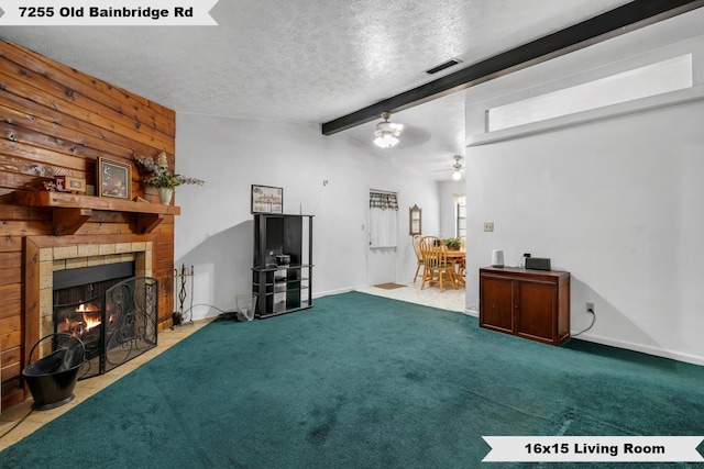 unfurnished living room featuring lofted ceiling with beams, carpet flooring, ceiling fan, a brick fireplace, and a textured ceiling