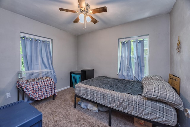 bedroom featuring ceiling fan and carpet