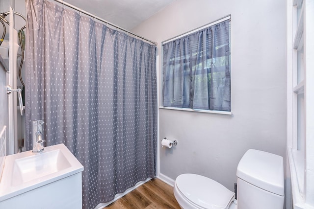 bathroom featuring sink, a shower with shower curtain, toilet, and wood-type flooring