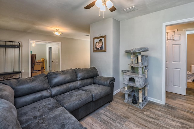 living room with hardwood / wood-style flooring and ceiling fan