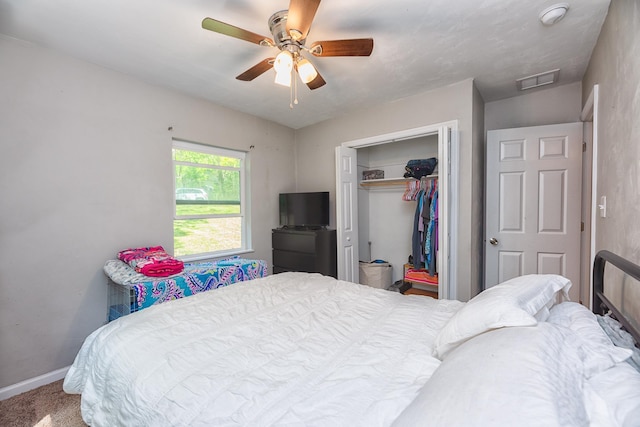 carpeted bedroom with a closet and ceiling fan