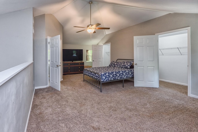 bedroom with light carpet, ceiling fan, vaulted ceiling, and a spacious closet