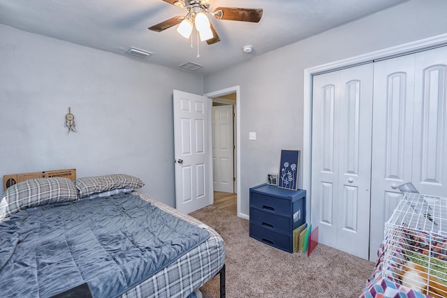 carpeted bedroom with a closet and ceiling fan