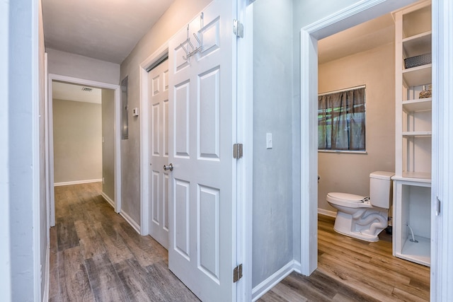 corridor with dark hardwood / wood-style flooring