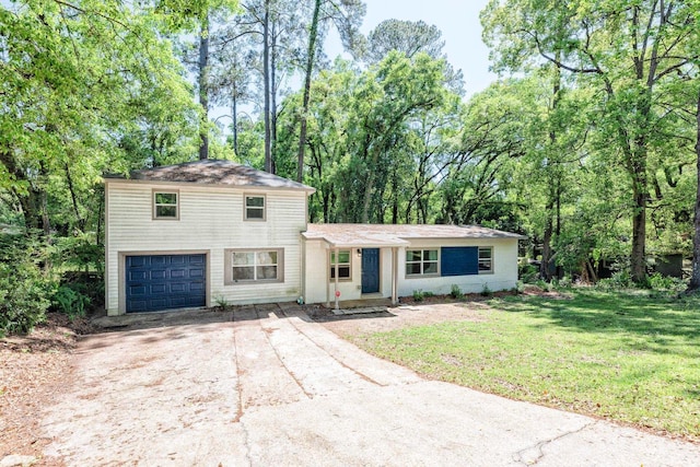 view of front of house with a front yard and a garage