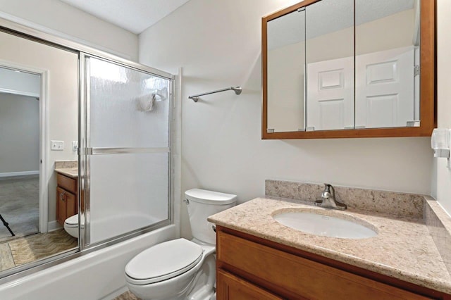 full bathroom with vanity, a textured ceiling, shower / bath combination with glass door, and toilet