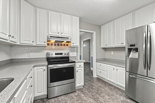 kitchen with white cabinetry, stainless steel appliances, and light stone counters