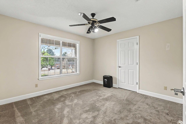 unfurnished room featuring ceiling fan, carpet floors, and a textured ceiling