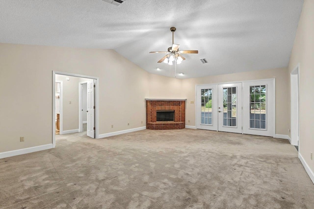 unfurnished living room with ceiling fan, a fireplace, a textured ceiling, light carpet, and vaulted ceiling