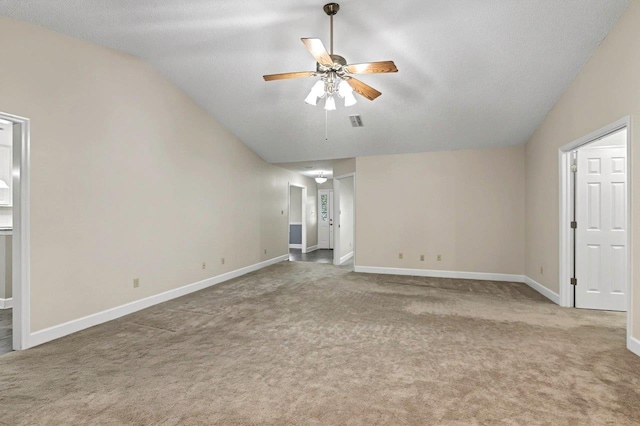 unfurnished living room featuring ceiling fan, lofted ceiling, carpet, and a textured ceiling