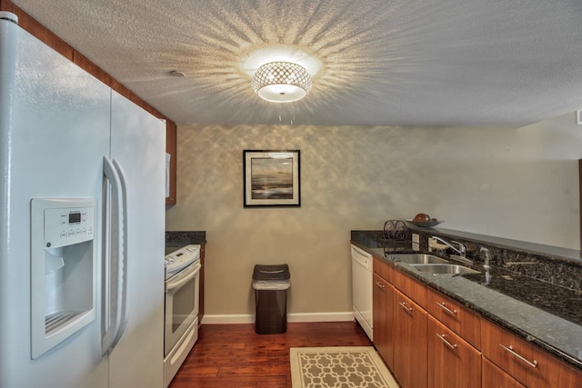 300 S Duval St Unit 1411, Tallahassee, FL 32301 - kitchen with sink, dark stone counters, dark hardwood / wood-style floors, a textured ceiling, and white appliances