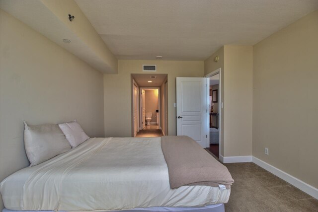 300 S Duval St Unit 1411, Tallahassee, FL 32301 - carpeted bedroom featuring baseboards and ensuite bathroom