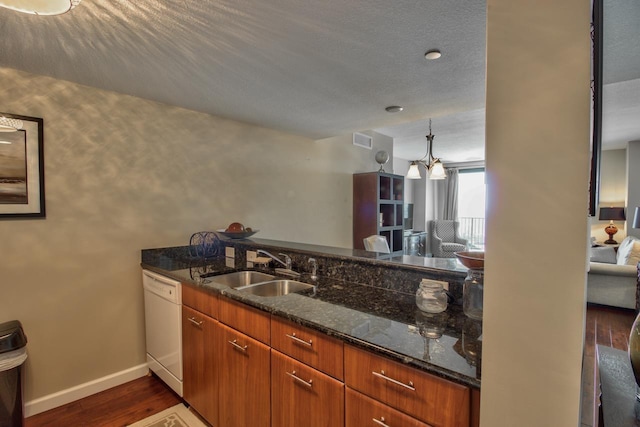 300 S Duval St Unit 1411, Tallahassee, FL 32301 - kitchen featuring white dishwasher, dark wood-type flooring, dark stone countertops, and brown cabinetry
