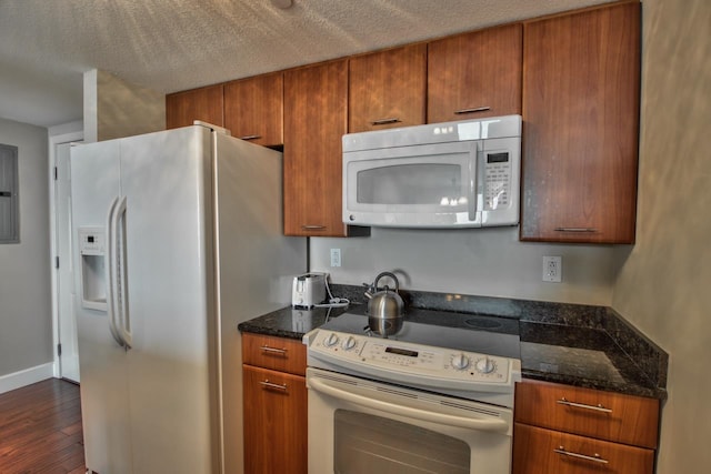300 S Duval St Unit 1411, Tallahassee, FL 32301 - kitchen with dark stone counters, white appliances, a textured ceiling, and dark hardwood / wood-style floors