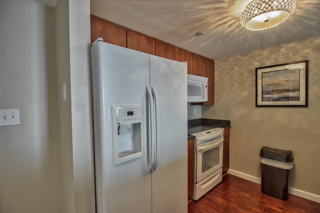 300 S Duval St Unit 1411, Tallahassee, FL 32301 - kitchen with white appliances, dark countertops, brown cabinetry, dark wood finished floors, and a textured ceiling