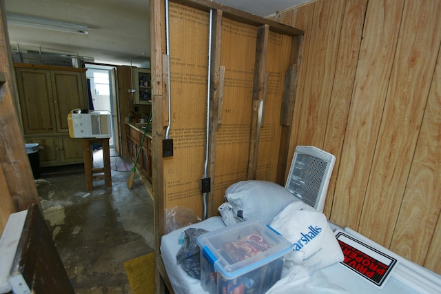 miscellaneous room featuring wood walls