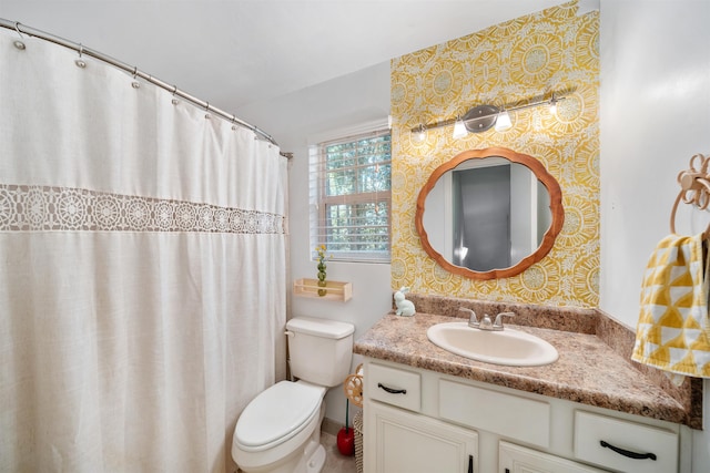 bathroom featuring vanity, a shower with shower curtain, and toilet