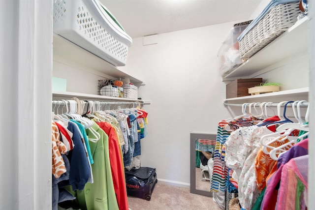 walk in closet featuring carpet