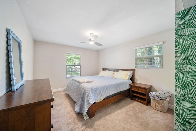 bedroom with carpet floors, a ceiling fan, and baseboards