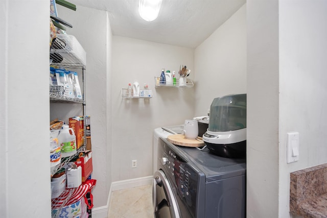 washroom with washer / dryer, tile patterned flooring, and laundry area