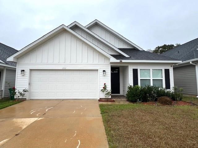 view of front of home with a garage and a front yard