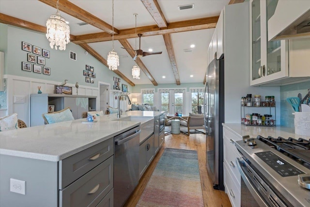 60 Southside Dr, Shell Point, FL 32327 - kitchen featuring stainless steel appliances, gray cabinets, open floor plan, light wood-style flooring, and a sink