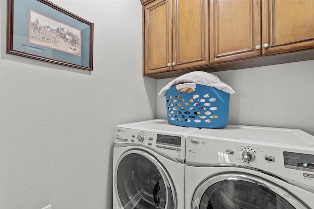 laundry area with cabinets and separate washer and dryer