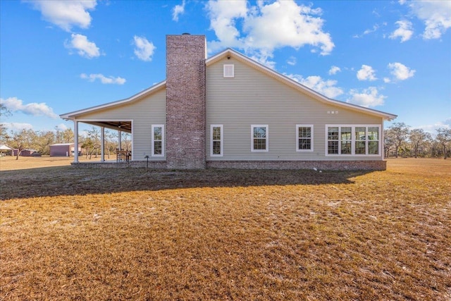 back of property featuring a yard and a patio area