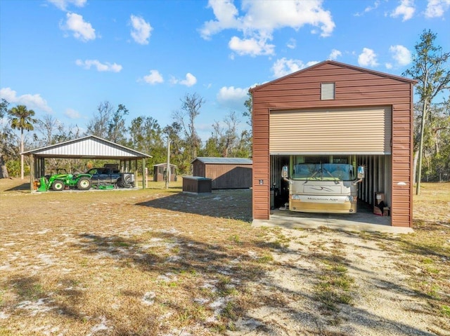 view of outdoor structure featuring a garage and a carport