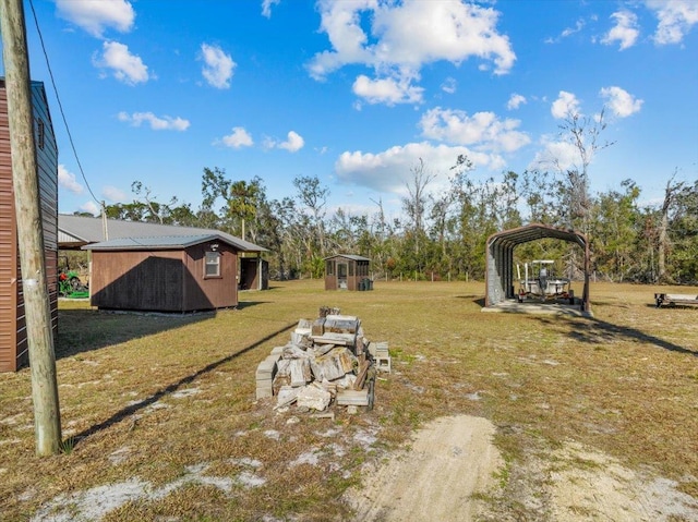 view of yard featuring a shed and a carport