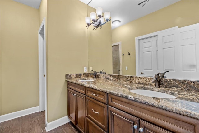 bathroom with vanity, a notable chandelier, and walk in shower