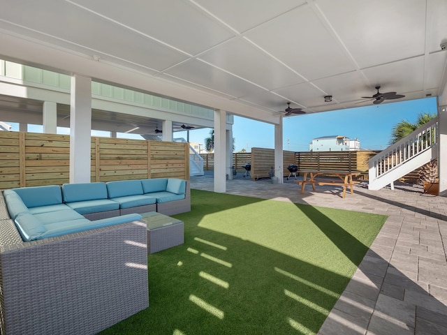 view of yard with an outdoor living space, a patio, and ceiling fan