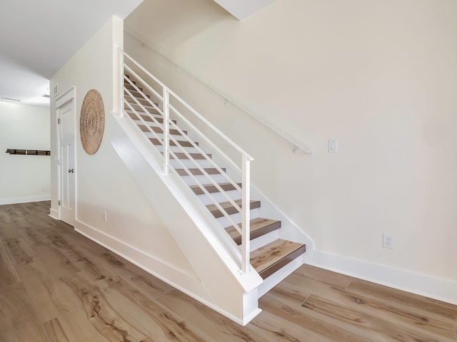 stairway featuring hardwood / wood-style floors