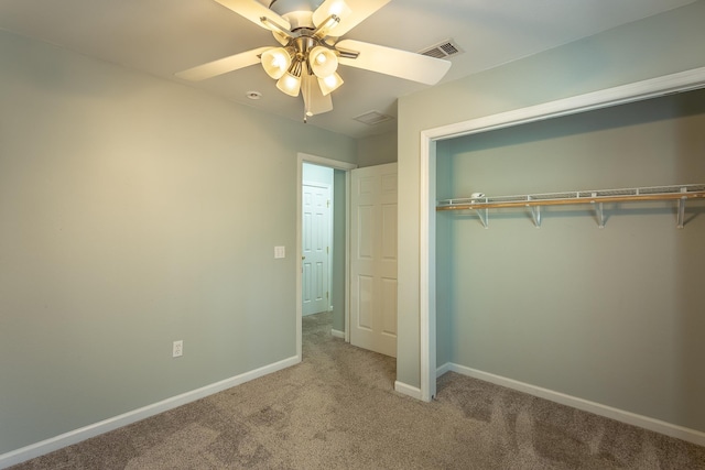 unfurnished bedroom featuring a closet, ceiling fan, and carpet flooring