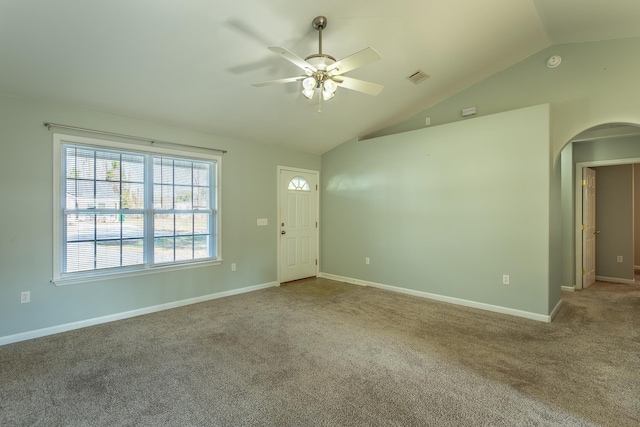 carpeted spare room featuring lofted ceiling and ceiling fan