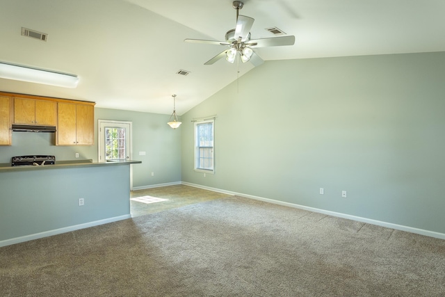 interior space featuring range, carpet floors, ceiling fan, and vaulted ceiling