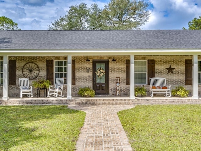 view of front of house with a porch and a front yard