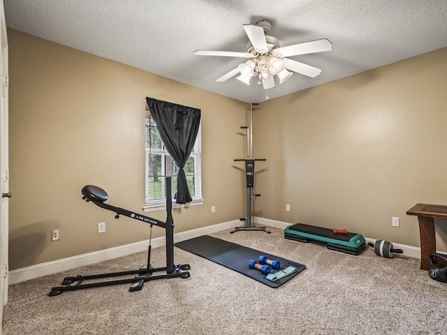 exercise area with ceiling fan, carpet floors, and a textured ceiling