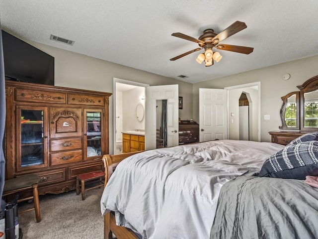 bedroom featuring lofted ceiling, connected bathroom, ceiling fan, and carpet flooring