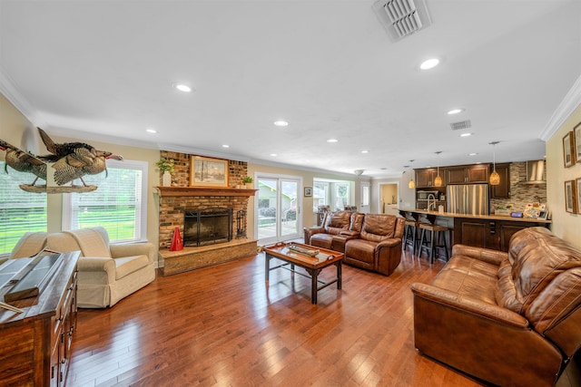 1178 Robin Kay Rd, Tallahassee, FL 32312 - living room featuring ornamental molding, plenty of natural light, wood-type flooring, recessed lighting, and a brick fireplace